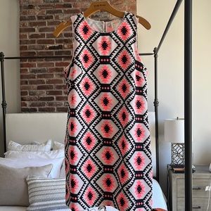 Flattering sleeveless shift dress with bead detail on neck and arms.